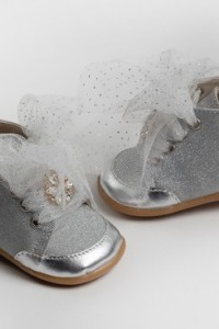 Baby girl first steps boot shoes made of leather and glitter textile, decorated with strass button
